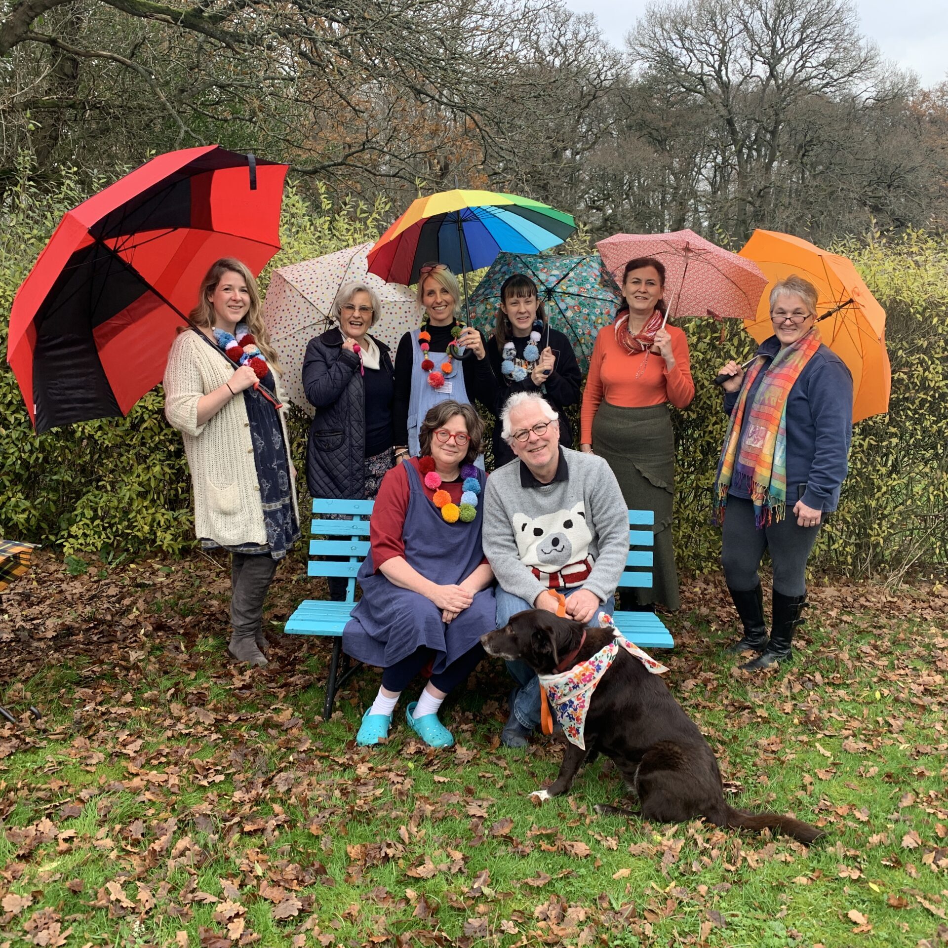 The Roelofs & Rubens team with colourful umbrellas in the Berkshire countryside